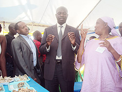 A farmer (R) talking to the Minister (C) as the Vice Chairman of PSF Faustin  Mbundu (L) looks on. (Photo/ S. Rwembeho)