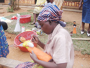 Busy at work. A woman busy paints her artifact.