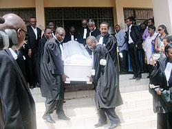 Colleagues carrying the coffin of former Bar chair Jean Haguma after he was honoured in the Supreme Court Chambers yesterday(Photo: Eugene Mutara)