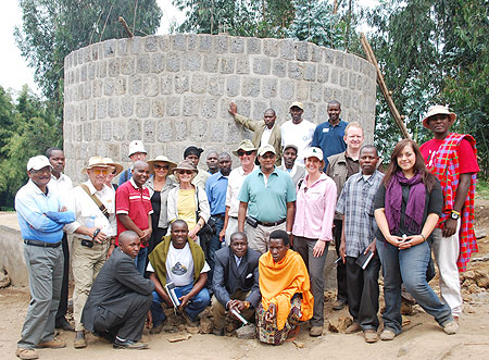 Karisoke Research Centre staff and residents pose for group photo in front of the newly built tank in Bisate (Courtesy photo)