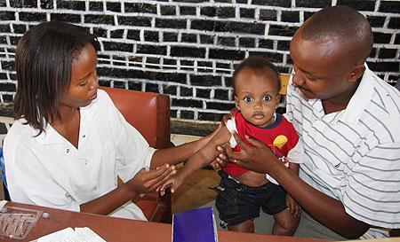  Jean Pierre Rwigamba is one of the fathers who turned up with his son Kecy Rwigamba for immunisation in Bugesera district. (Photo by Sam Nkurunziza)