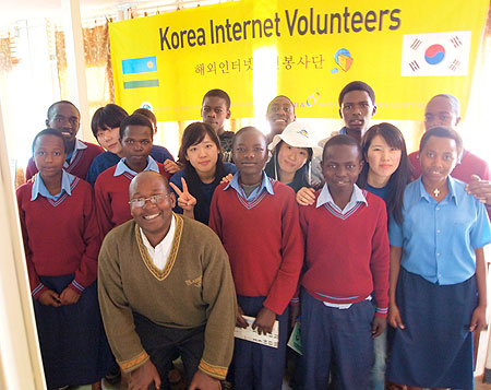 The headmaster of Academie de La Salle Burasa  (wearing spectacles)posing  with students and Korean volunteers. Photo A Gahene)