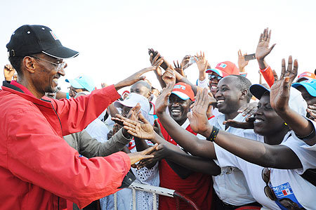 Kagame greets cheerful RPF supporters at a campaign rally, yesterday (Photo: Adam Scotti)