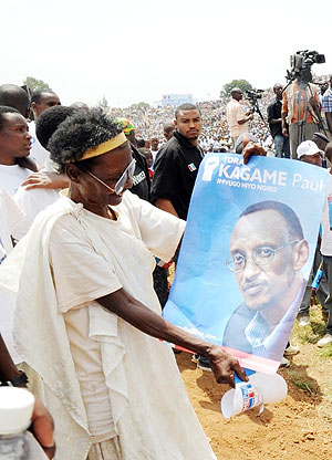 An elderly  Gicumbi woman shows off her  admiration for Kagame