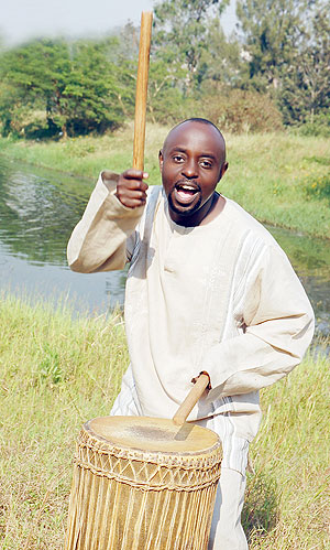 Hard at work. Peter Barnabas beats a drum.