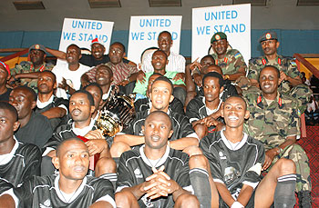 Prime Minister Bernard Makuza (Centre back row) joins APR football club in celebrations after they won the United We Stand Tournament trophy.(Photo: G. Kirenga)