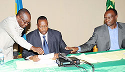 PLu2019s Protais Mitali (C),Prosper Higiro (R) and Francois Byabarumwanzi, consult during the press conference yesterday. (Photo J Mbanda)