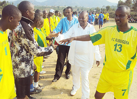 Karongi district mayor Bernard Kayumba (wearing jersey number 13) introducing his team to Governor Cu00e9lestin Kabahizi (wearing white track suit). [Photo: S. Nkurunziza]