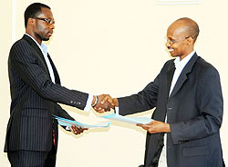 Orinfor Director Willy Rukundo (R) shaking hands with Optima Sports Management Representative Doza Loua to screen Europeu2019s elite leagues.(Photo F.Goodman)