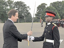 Sandhurstu2019s graduate Ramsey Simba(L) with British Premier David Cameron during the pass out (Courtesy photo)