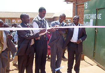 A representative of National Genocide students association (second from left) Clement Kayitakire cuts tape to launch AERG at IPB. (Photo: A. Gahene)