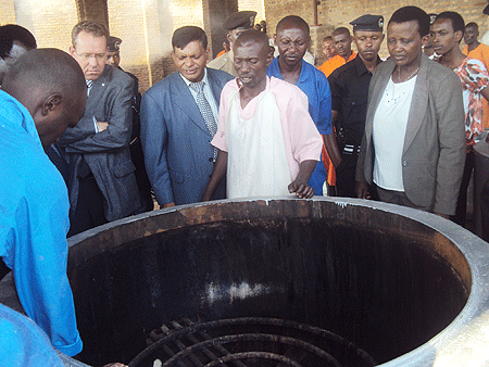 Borrowing a leaf from Prisons -  Prisons boss, Mary Gahonzire (R) and and other officials observe the use of biogas in cooking. Photo by S. Rwembeho.