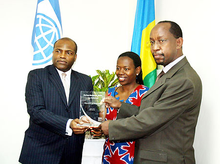 IFC Director, Jean Phillipe Prosper (L) hands trophy to Minister Nsanzabaganwa (c) and the CEO of RDB, John Gara (R), yesterday. (Courtesy photo)