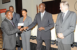 The Minister of Labour, Anastase Murekezi awarding Clement Dusabe of Envirotech (Photo J. Mbanda)