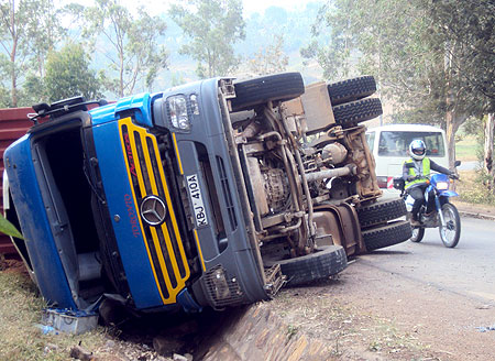 The overturned truck that was involved in an accident along the Butare Kigali highway. (Photo By D. Nzigiyimana)