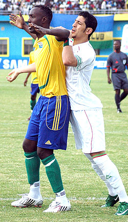 TIRED MUSCLES:  Karekezi shoulders off an Algerian defender during a 2010 African Nations Cup qualifier. (File Photo)