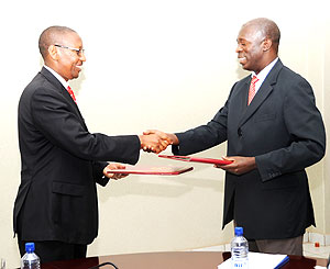 Ministers John Rwangombwa (left) and Anastase Murekezi during the handover ceremony yesterday (Photo: F. Goodman)