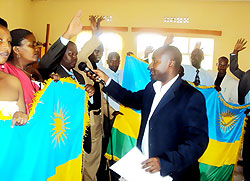 Gasabo Mayor Willy Ndizeye leading the District  Executive Secretary through the oath yesterday (Photo S. Mugisha)