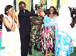 NECu2019s vice president Fatu Harerimana hands over the trophy to Jean Damascu00e8ne Nsanzimfura, the  vice mayor in charge of economic development. (Photo: S. Nkurunziza)