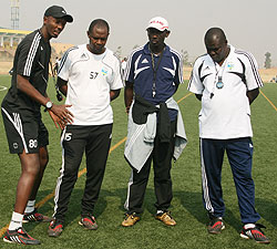 Amavubi Stars coaching staff brainstorming after the teamu2019s last training session before leaving for Ivory Coast on Wednesday, right Sellas Tetteh listens as his assistant Eric Nshimiyimana (L) talks. (Photo/ E. Niyonshuti)