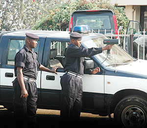Sup. Benoit Nsengiyumva trains a speed gun on an an approaching car. Police has extended such gadgets to rural areas (File Photo)