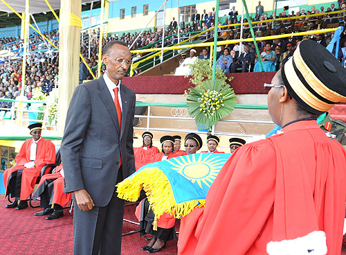 President Kagame receiving the national flag, one of the instruments of power, from Chief Justice Aloisea Cyanzaire, shortly after swearing-in (Photo Urugwiro Village)