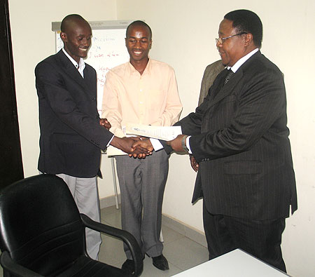 Prof. John Mushana awarding students with the best business plan project (Courtesy photo)