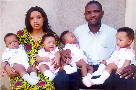 The quadruplets at six months with their parents.