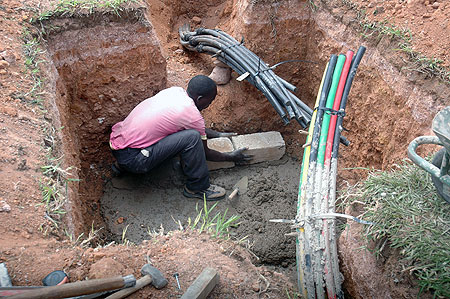 A man lays Fibre Optic cables. Several of these projects that are already underway will spur development of the country (File photo)