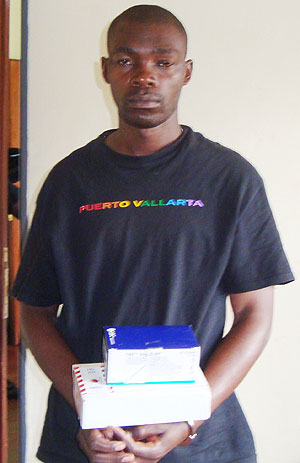 ARRESTED; Eric Mugabo holding some of the stolen HIV screening testsu2019 kits(Courtesy photo)