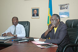 Ombudsman Tito Rutaremara(R) making addressing the media recently as the Minister of Labour and Public Service, Anastase Murekezi looks on (File photo)