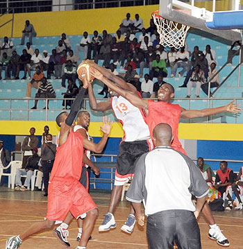 KBCu2019s Fiston Muhire fights for the ball with two Ferwaba Select players. KBC won the contest 81-42. (Photo J. Mbanda)