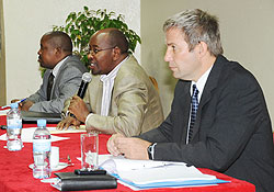 The Minister of Local Government, James Musoni (C) addressing the meeting while Ejide Rugamba (L) and Stephan Klingebeil(R) look on (Photo; T. Kisambira)
