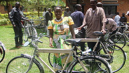 Bernadette Namakura one of the mediators admires her bicycle (Photo; S. Rwembeho)