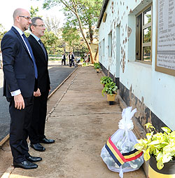 L-R; Charles Michel and Andris Piebalgs honouring the fallen Belgian  soldiers at Camp Kigali yesterday (Photo T. Kisambira)