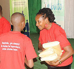 The Director General in the Office of the First lady, Radegonde Ndejuru handing over prizes to students yesterday (Photo; T. Kisambira)