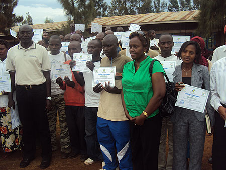 Trainees pose with their certificates in a group photo (Photo; S. Rwembeho)