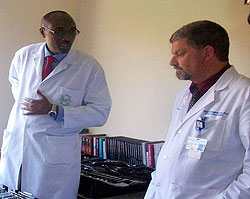 Dr. Nkusi Emmanuel, (c) receiving the new equipment from Dr. Michael Haglund of Duke University (Courtesy photo)