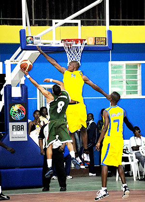 Rwandau2019s Kapongo goes in for a block against an Algerian player on Friday. Rwanda yesterday lost 92-65 to Nigeria. (Photo; T.Kisambira)