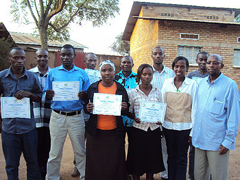 Mugina sector local leaders pose with RISD staff after receiving certificates of participation (Photo; D.Sabiiti)