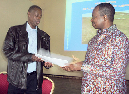 Minister Karega hands over symbolic documents to Gen Kabarebe, the new Rubavu guardian (Photo / R.Mugabe)