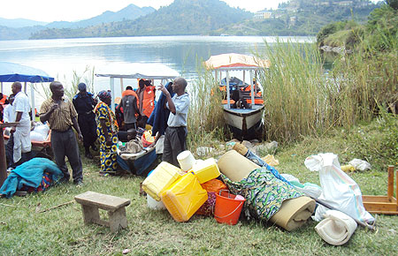 Residents prepare to board awaiting boats upon eviction from the island yesterday (Photo S Nkurunziza)