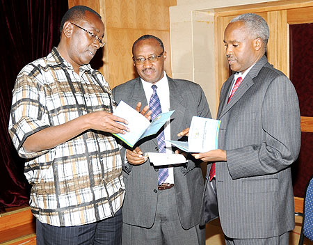 Prime Minister Bernard Makuza (L) with Ministers Protais Musoni (C) and Charles Murigande read through the 2010-2017 Government roadmap paper yesterday. (Photo J Mbanda)