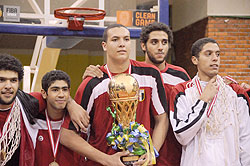 Egyptu2019s Aly Mohammad showing off the winnersu2019 trophy yesterday at Amahoro Indoor Stadium. (Photo T. Kisambira)