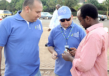 Tigo's top executives Diego Camberos and Marcelo Aleman, the CEO (in middle) sell airtime to a reveller in a recent 'Go Sale' activity (File Photo)