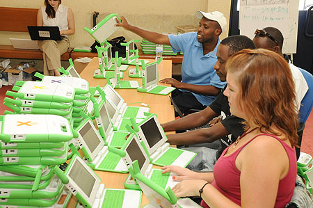OLPC technicians installing software prior to delivering the laptops to schools (Photo / T. Kisambira)