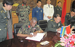 The Minister Oof Defence, Gen. James Kabarebe and his Chinese counterpart,Gen Liang Guanglie, signing the cooperation agreement yesterday.