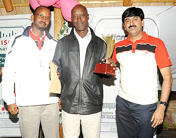 Winneru2019s smile: Joseph Semwaya (C) gets his prize after winning the Presidents Cup on Sunday. On the left is former Kigali Golf Club president Marcel Byusa and tournament sponsor, Bin Thomas. (Photo: J. Mbanda) 
