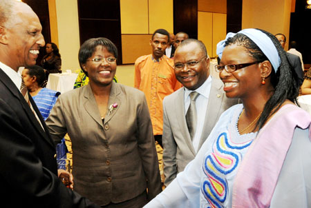 Ms. Letty Chiwara, UNIFEM Chief of Africa Section (R) chats with Jean Sayinzoga of NDRC (L), as the Minister of Gender, Jeanne du2019Arc Mujawamariya and UN resident coordinator Aurelien Agbenonci look on, (photo T Kisambira) 