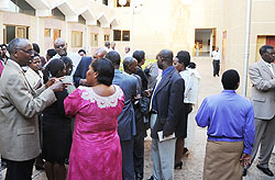 Members of Parliament during consultations outside the house yesterday (Photo; J. Mbanda)